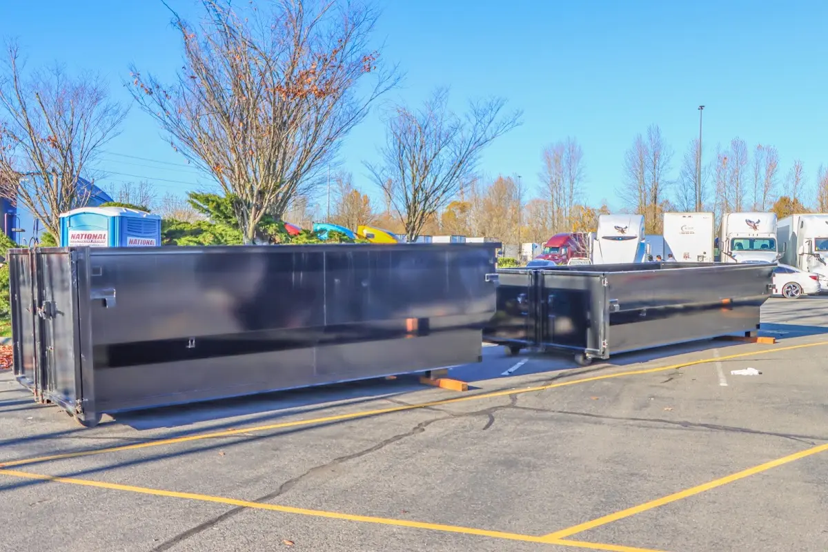 Professional dumpster rental service with roll-off container on residential driveway in Orange City